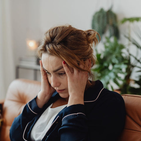 A woman holding her head